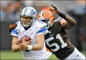 Detroit Lions quarterback Matthew Stafford is chased by Browns linebacker Barkevious Mingo in the second quarter Sunday in Cleveland. Stafford threw four touchdown passes in Detroit's win.