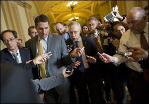 Senate Majority Leader Sen. Harry Reid, D-Nev., is surrounded by reporters after leaving the office of Senate Minority Leader Sen. Mitch McConnell, R-Ken., on Capitol Hill today.