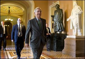 Senate Minority Leader Mitch McConnell, R-Ken., walks to his office after arriving on Capitol Hill today 