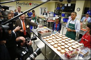 President Barack Obama speaks to reporters as he visits Martha's Table, which prepares meals for the poor and where furloughed federal employees are volunteering today in Washington.