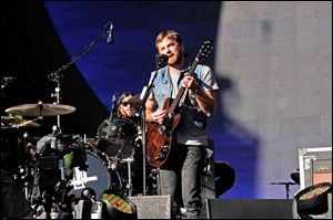 Musicians Caleb Followill, on guitar, and Nathan Followill, on drums, of Kings of Leon perform at the 2013 Global Citizen Festival in Central Park in September in New York City. 