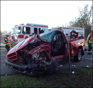 Emergency personnel investigate the scene Wed-nesday  of a crash between a school bus and pickup truck in Lenawee County. Three people remain hospitalized.