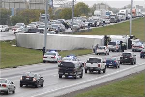 A semi tractor-trailer overturned from a two car collision on I-475 / U.S. 23 just north of Airport Highway.