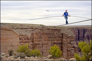 Nik Wallenda nears the completion of his 1,400-foot walk across the Grand Canyon for Discovery Channel's Skywire Live With Nik Wallenda in June.