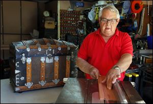 Al Obst works on a trunk at his Lambertville home.