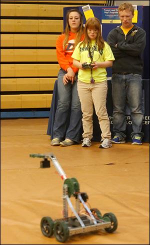 Bethany Wissler, 19, center, operates a robot constructed by members of Project Lead the Way, a pre-engineering program.