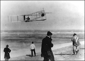 In this undated file photo, Orville and Wilbur Wright test their airplane on a North Carolina beach.