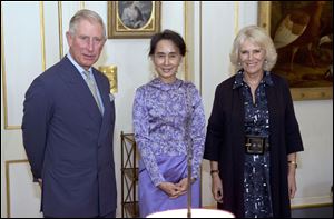 Myanmar opposition leader Aung San Suu Kyi , centre, stands with Britain's  Prince Charles Camilla  Duchess of Cornwall during a meeting Wednesday at Clarence House, in London.