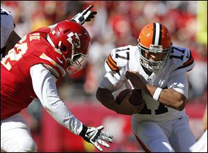 Chiefs nose tackle Dontari Poe, left, moves in to hit Cleveland Browns quarterback Jason Campbell during the first half Sunday in Kansas City.