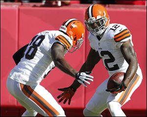 Cleveland Browns wide receiver Josh Gordon, right, celebrates his touchdown with teammate Greg Little during the first half Sunday in Kansas City.