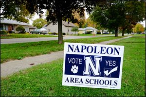 A yard sign urges voters in Napoleon to support a 2.9-mill, five-year school levy. Tuesday will mark the district’s latest attempt to secure new operating funds.