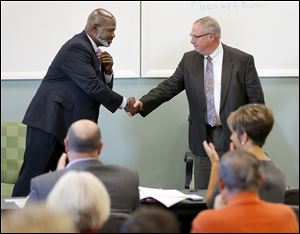 Toledo Mayor Mike Bell and challenger D. Michael Collins, a city councilman shake hands after taking part in a candidate forum. Both are running as independents.