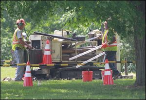 AECOM workers prepare to take another soil samples are at the former Whirlpool Park as part of an examination of the property for contamination at the park in Green Springs, Ohio in May.