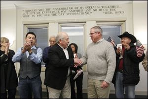 Baldemar Velasquez, president of FLOC, left, and D. Michael Collins for mayor shake after Mr. Velasquez endorsed Mr. Collins for mayor of Toledo.