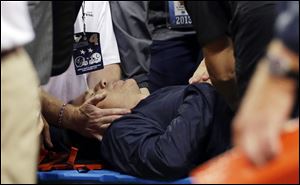 Houston Texans head coach Gary Kubiak, center, is helped after he collapsed on the field during the second quarter of an NFL football game Sunday in Houston.