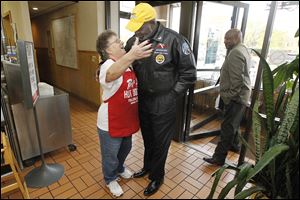 Mayor Mike Bell is welcomed to Rudy's Hot Dog in Point Place by manager Yiota Proestos on the afternoon before the election.