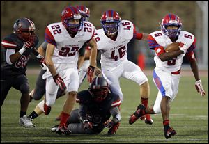 St. Francis de Sales running back Lamar Carswell  runs the ball against Central Catholic. The junior leads the Knights in rushing with 1,248 yards on 177 carries and has scored 13 touchdowns.