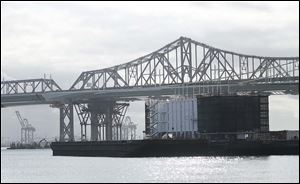 A barge belonging to Google sits near the eastern span of the San Francisco-Oakland Bay Bridge. The barge is one of two mysterious floating structures connected to the tech giant that have sparked online speculation. 