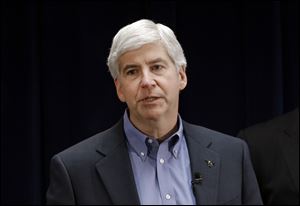 Michigan Gov. Rick Snyder signs into law a measure to charge sex offenders a $50 annual registration fee. 