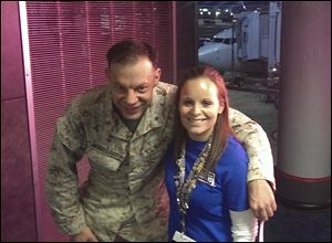 Lindsy Wadas, director of the USO Center at Chicago's O'Hare International Airport with U.S. Marine Maj. Matthew Winkelbauer, left, after he and 13 other Marines arrived.