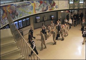 A group of Marines walk through a terminal at Chicago's O'Hare International Airport  during part of their journey back home after a tour of duty in Afghanistan. 