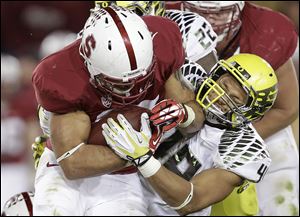 Stanford running back Tyler Gaffney, left, attempts to run past Oregon linebacker Rodney Hardrick during the second quarter Thursday night in Stanford, Calif. Gaffney ran 45 times for 157 yards in the Cardinal's win.