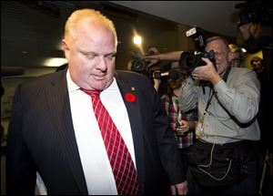 City of Toronto Mayor Rob Ford leaves his office for the day Friday in Toronto.