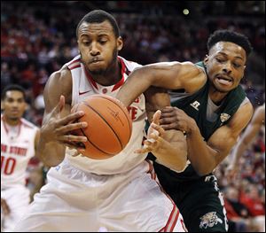 Ohio State's Trey McDonald, left, and Ohio University's T.J. Hall go for a rebound during the first half.