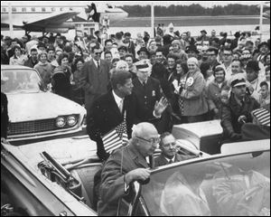 Senator John F. Kennedy, (D-Ma.)waves to onlookers after landing at Toledo Express Airport during the 1960 Presidential campaign.