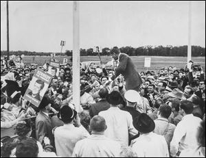 John F. Kennedy greets some of the 1,200 people who turned out at Toledo Express Airport during his Nov. 4, 1960, campaign visit. Later, a crowd of 25,000 converged on the Lucas County Courthouse to see him speak.