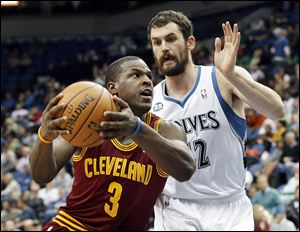 Cleveland's Dion Waiters drives around Minnesota's Kevin Love. Waiters has missed the last two games.