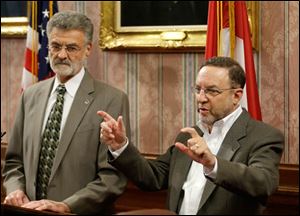 Cleveland Browns CEO Joe Banner, right, speaks during a news conference with Cleveland Mayor Frank Jackson, left, at City Hall today, Nov. 19, 2013. 