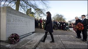 Tatiana Schlossberg, granddaughter of President John F. Kennedy, lays a wreath at his memorial at Runnymede, England. The memorial overlooks the site of the signing of the Magna Charta.