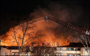 Firefighters battle flames at the Brandywine condominium com-plex in November, 2012, in Monclova Township.