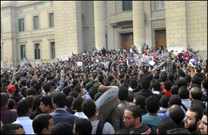 Student protesters gather inside the Cairo University campus before marching into the streets, in Cairo, Egypt today.