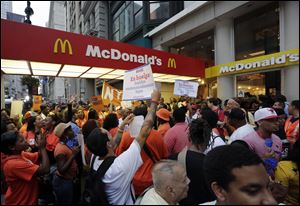 Protesting fast food workers demonstrate outside a McDonald's restaurant on New York's Fifth Avenue, in New York in August.