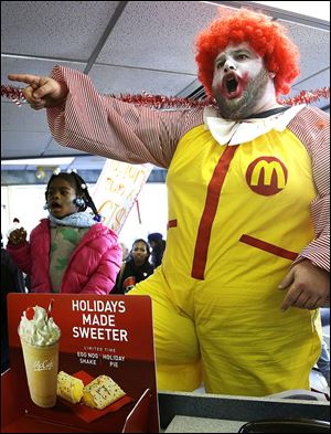 Protesters chant inside a McDonald’s restaurant in Oakland, Calif. Protests were held nationwide as unions and worker advocacy groups as well as Democrats renewed a drive for an increase in the federal minimum wage.