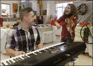 CTY holiday08p  The 14th Street Duet--Connor Savino (cq), 18, left, and Pilar (cq) Athaide-Victor (cq), 15,--in the Hands-On Studio at the TBG. Savino is a senior and Athaide-Victor a sophomore at the Toledo School for the Arts.      The annual Heralding the Holidays at the Toledo Botanical Garden in Toledo, Ohio on December 7, 2013.  Unique gifts, jewelry, artwork, and herbs are part of this year's offerings. In addition, attendees have a chance to make an ornament at the with help from a member of the Toledo Area Glass Guild in the Artists Village, and, for the first time, to make a wreath with help from the students in the Natural Science Technology Program of Toledo Public Schools which is next to the garden.    The Blade/Jetta Fraser