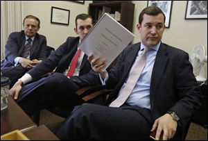 From left, Dock Treece, and sons Ben and Dock David, meet with Blade editors about their proposal to to privatize Toledo Express Airport on Wednesday, Dec. 4. Dock David is holding the proposal.  