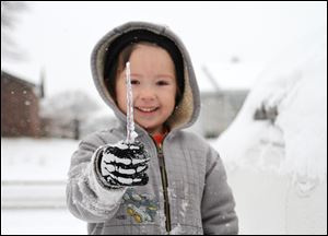 Jared Shepard, 5, plays in the snow in his front yard after several inches of snow and ice blanketed the area Friday in Van Buren, Ark.