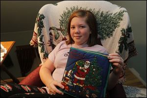 Lizzy Pennington, 11, with a cloth book of 