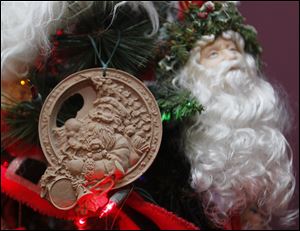 Two Santa Claus ornaments on Mrs. Christenson's always-up tree. The one on the left is made from crushed pecan shells.