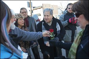 CTY ezekiel08p Ezekiel Villa, 80, center, is greeted by friends, family and community members as he arrives for the official unveiling of signage declaring the intersection of South Avenue and Spencer Street to be Ezekiel Villa Corner Saturday, Dec. 7, 2013, at the intersection in South Toledo. Villa, the owner of the South Toledo El Tipico Restaurant, was honored at a Nov. 26, 2013, city council meeting for 