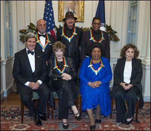 Secretary of State John Kerry, with the 2013 Kennedy Center honorees, from left, seated Shirley MacLain, and Martina Arroyo, along with Teresa Heinz Kerry. Standing are Billy Joel, Carlos Santana, and Herbie Hancock.