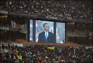 President Obama speaks to mourners attending the memorial service at the FNB Stadium in Soweto near Johannesburg.