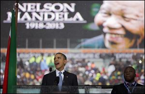 President Obama speaks to crowds attending the memorial service for former South African president Nelson Mandela at the FNB Stadium in Soweto.