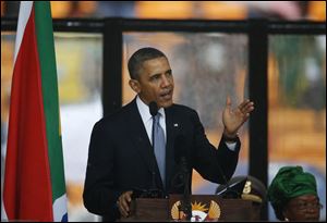 President Obama speaks to crowds attending the memorial service for former South African president Nelson Mandela at the FNB Stadium in Soweto near Johannesburg today.