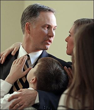 Dave Clawson embraces his son, Eric, and his wife, Catherine, after Tuesday’s news conference. His daughter, Courtney, is front right.