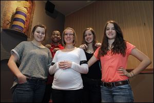 Brianna Wielinski, Terrell Hutcherson, teacher Danielle Pickle, Sophia Sokoloski, and Katie Kirk, from left, stand in front of the time capsule at the Maumee Indoor Theater. The time capsule is part of a year-long celebration of Maumee's 175th anniversary.