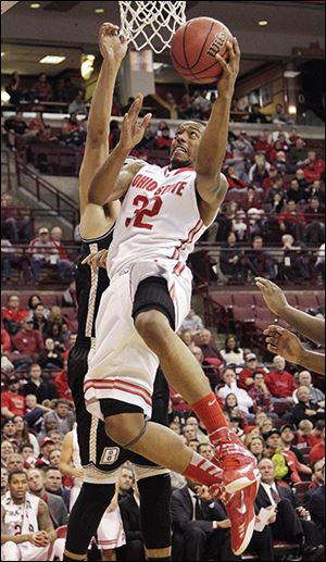 Ohio State's Lenzelle Smith, front, shoots over Bryant's Claybrin McMath during the second half.